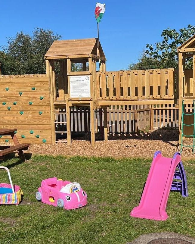 The wooden climbing frame with towers and slides in the beer garden